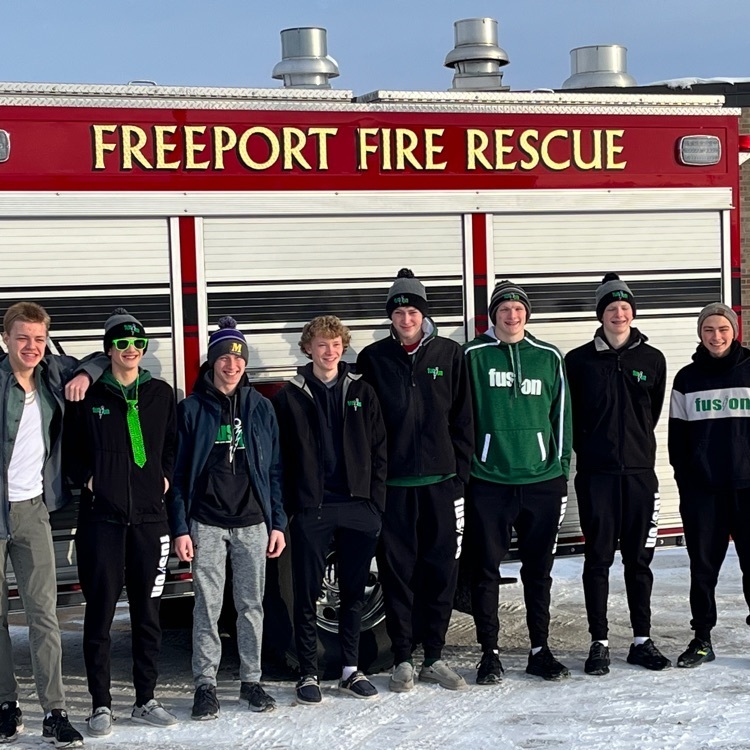 Fusion swim/dive team in front of a fire truck 