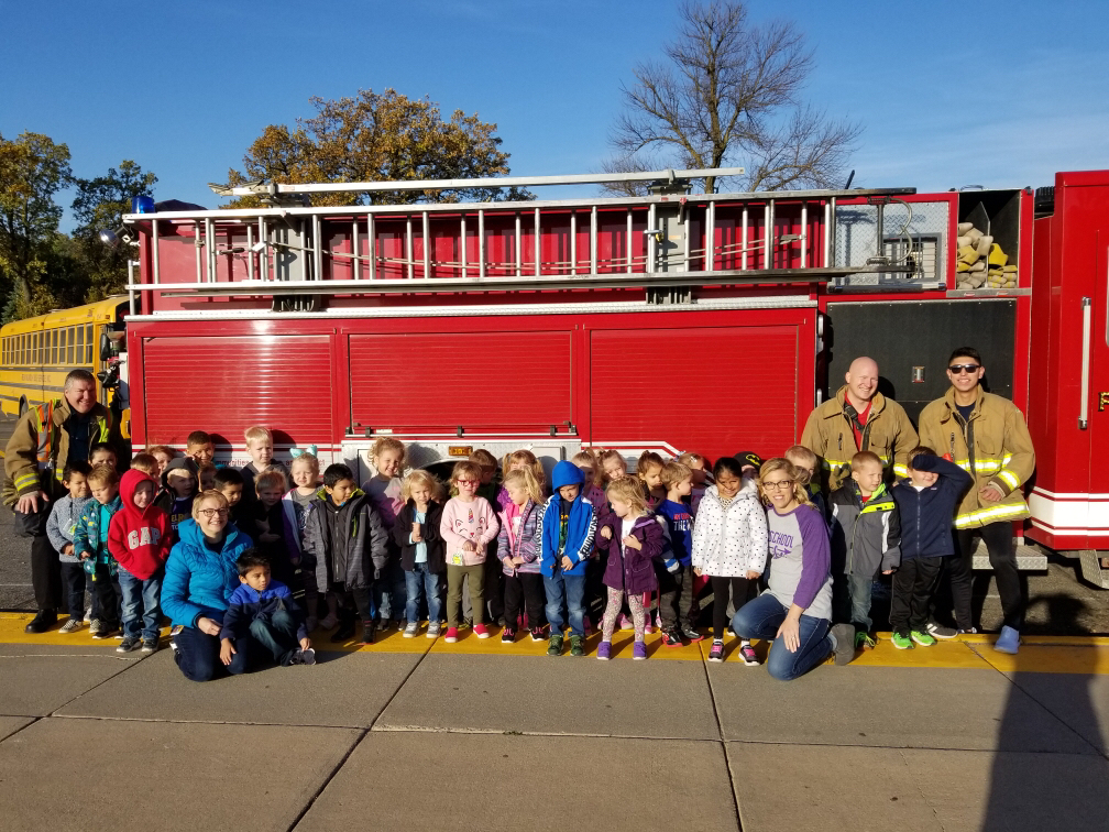 Preschoolers with a fire truck. 